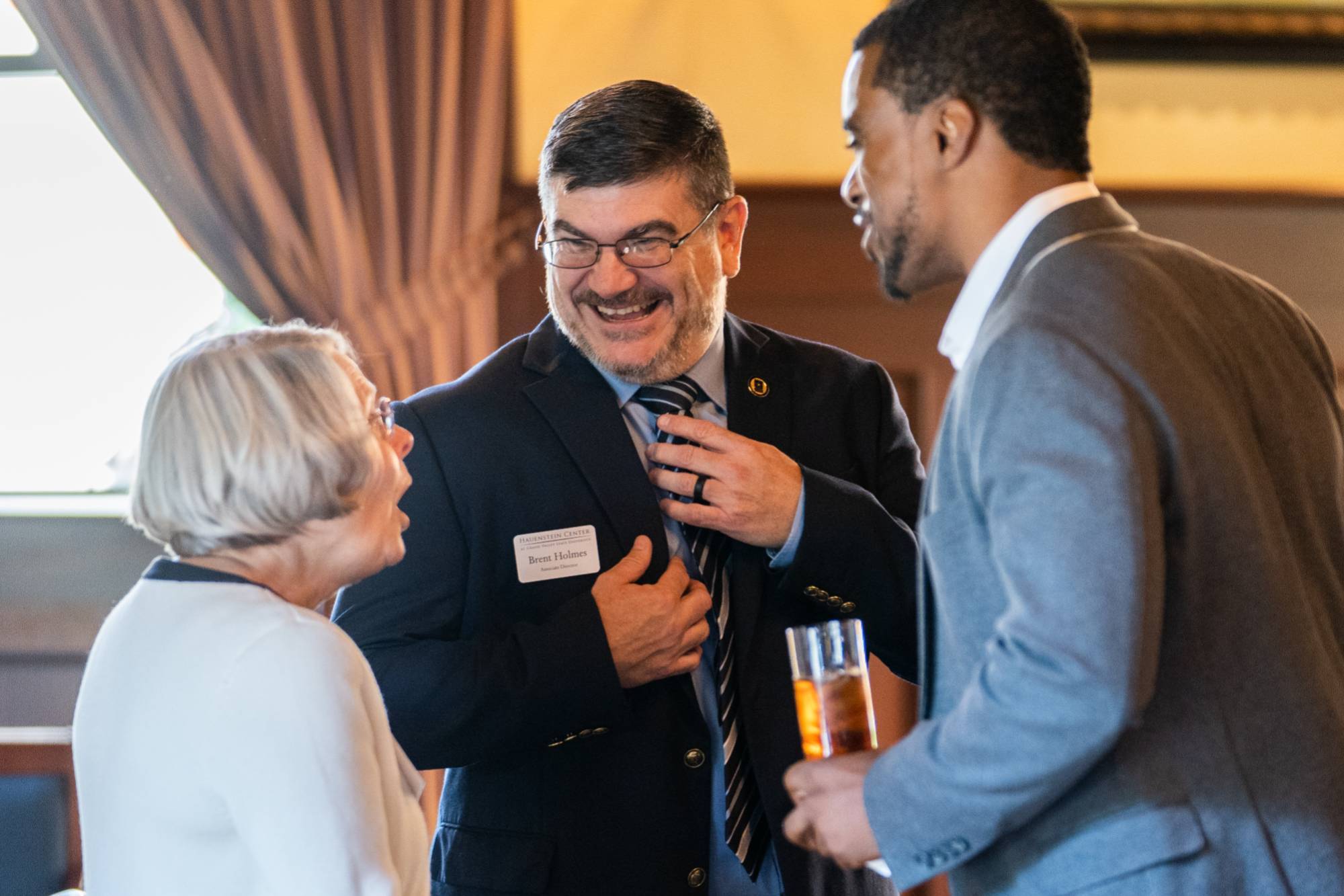 Hauenstein Center Associate Director Brent Holmes laughs in discussion with event attendees.